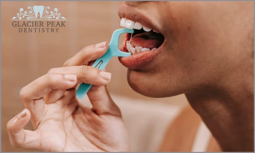 Flossing To Get Rid Of Food Debris Stuck Within The Teeth
